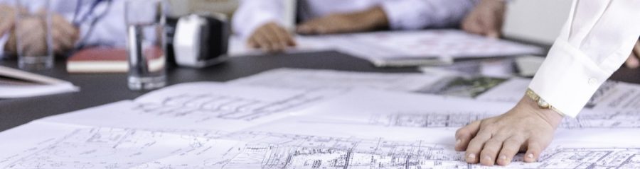 Blueprints at conference table